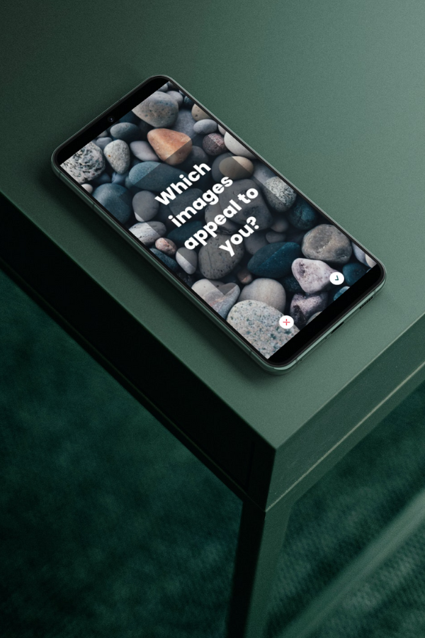 A smartphone displaying Swipe Journeys for Surveys with an image of pebbles and a text: "Which images appeal to you?"